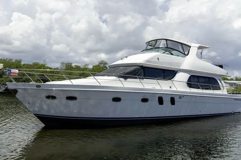 Slide: The Image of 2007 Carver 56 Voyager SE yacht on calm water under cloudy sky. - 1
