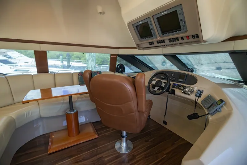 Slide: The Image of Luxurious 2007 Carver 56 Voyager SE yacht interior with helm, leather seating, and navigation equipment. - 25