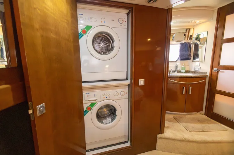 Slide: The Image of Laundry area in 2007 Carver 56 Voyager SE yacht with stacked washer and dryer. - 29