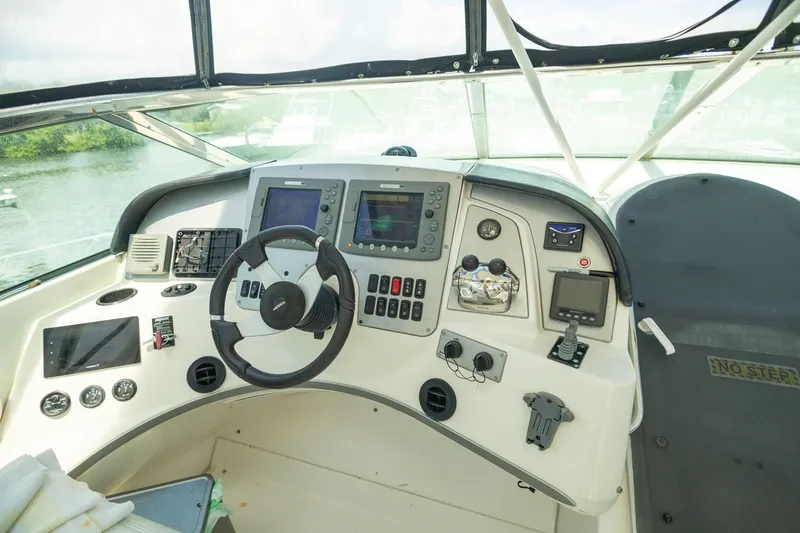 Slide: The Image of 2007 Carver 56 Voyager SE helm with advanced navigation controls and steering wheel. - 36