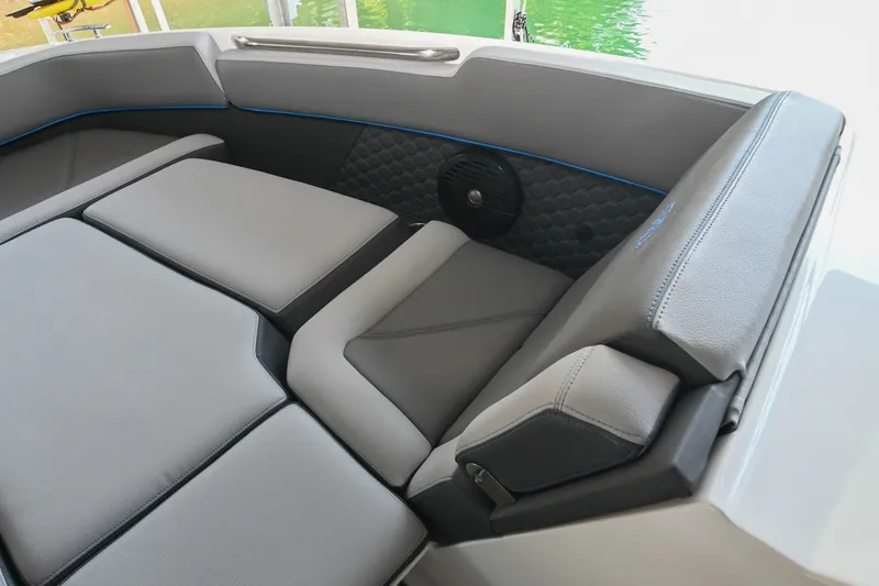 Slide: The Image of 2022 Cobalt R8 Surf boat interior with gray cushioned seating and speaker detail. - 44