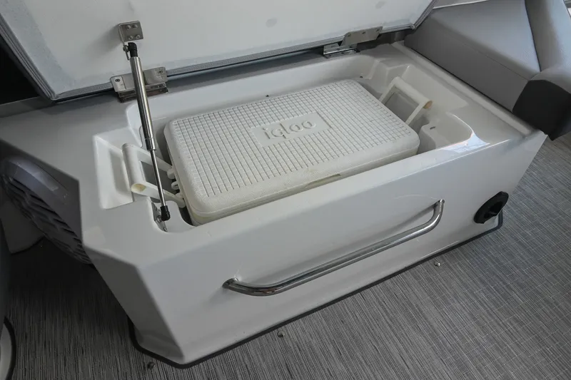Slide: The Image of Built-in cooler storage on 2022 Cobalt R8 Surf boat, featuring an Igloo cooler. - 26