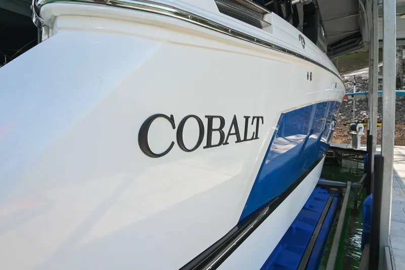 Slide: The Image of 2022 Cobalt R8 Surf boat in dock, showcasing sleek design and branding. - 4