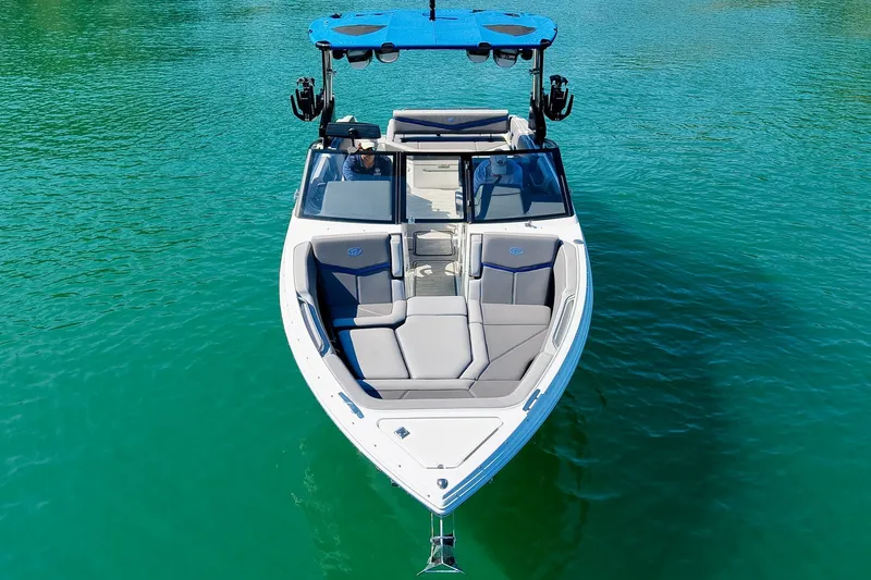 Slide: The Image of 2022 Cobalt R8 Surf boat on clear turquoise water, showcasing sleek design and spacious seating. - 15