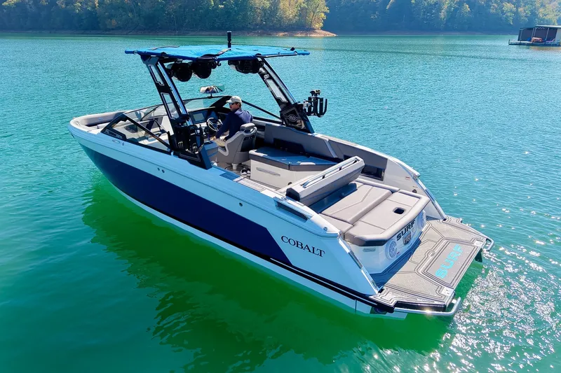 Slide: The Image of 2022 Cobalt R8 Surf boat on clear blue water, featuring sleek design and modern amenities. - 19