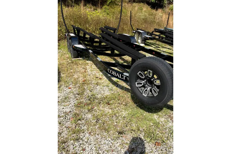 Slide: The Image of Trailer for 2022 Cobalt R8 Surf boat on grassy terrain. - 75