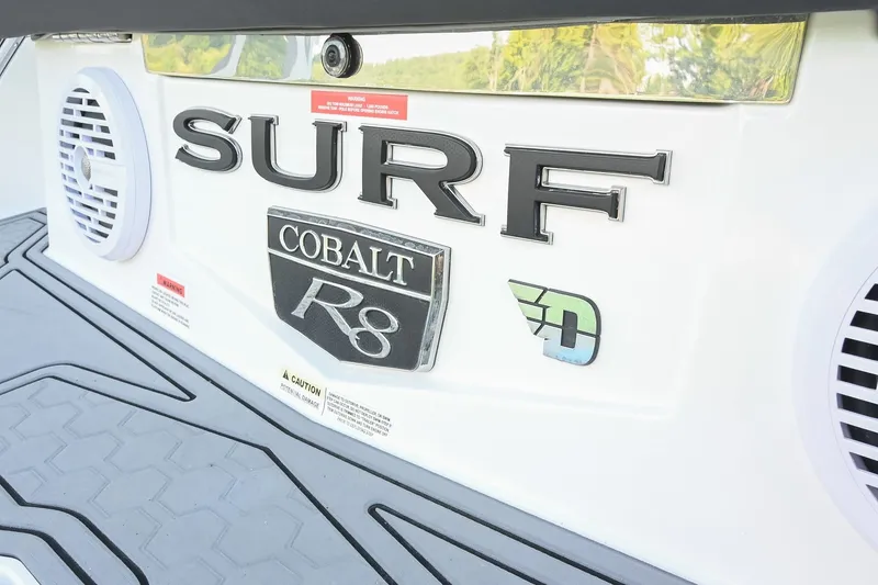 Slide: The Image of 2022 Cobalt R8 Surf boat rear view with branding and speakers. - 8