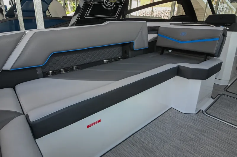 Slide: The Image of 2022 Cobalt R8 Surf boat interior with sleek gray seating and blue accents. - 20