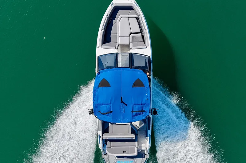 Slide: The Image of Aerial view of 2022 Cobalt R8 Surf boat cruising on clear water. - 21