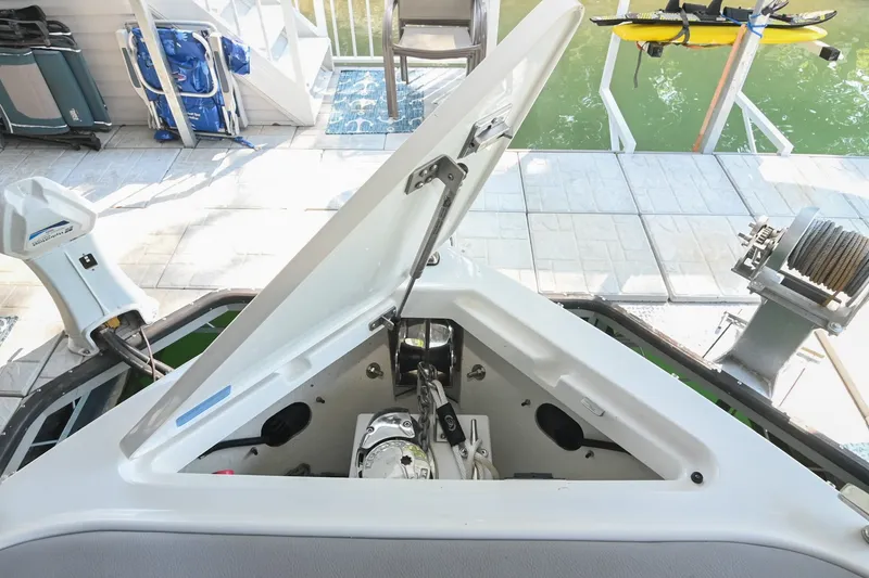 Slide: The Image of 2022 Cobalt R8 Surf boat with open storage compartment at dockside. - 49
