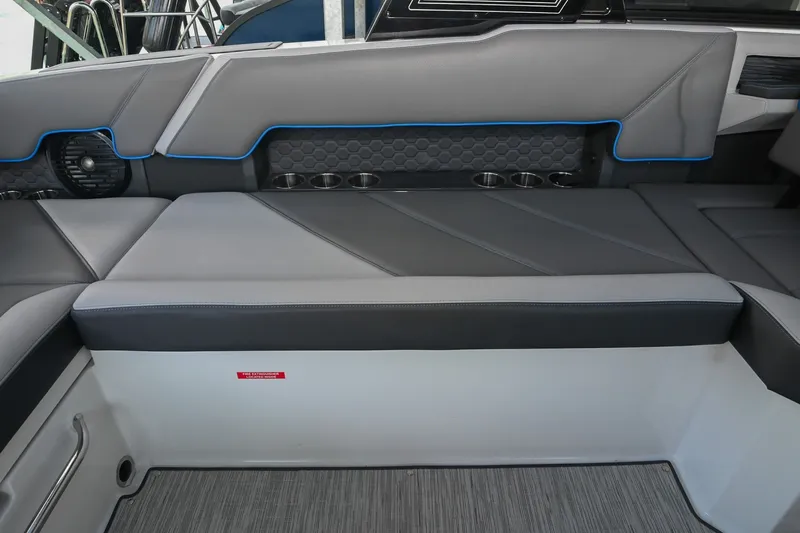 Slide: The Image of 2022 Cobalt R8 Surf boat interior with gray seating and cup holders. - 21