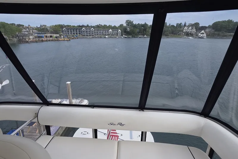 Slide: The Image of View from 2005 Sea Ray 550 Sedan Bridge overlooking serene waterfront and distant buildings. - 27