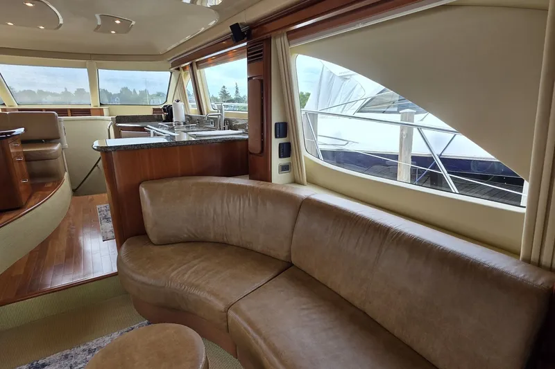 Slide: The Image of Luxurious interior of 2005 Sea Ray 550 Sedan Bridge yacht with leather seating and modern kitchen. - 42