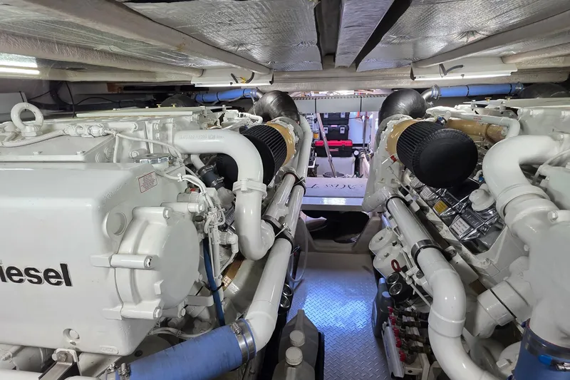 Slide: The Image of Engine room of a 2005 Sea Ray 550 Sedan Bridge yacht, showcasing dual diesel engines. - 87