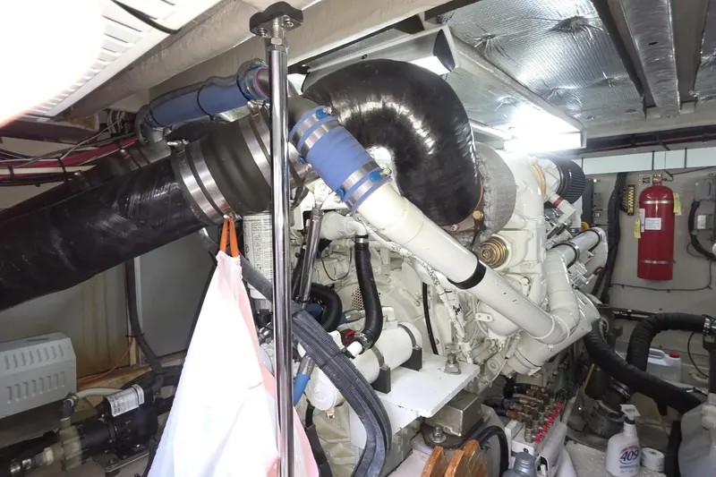 Slide: The Image of Engine room of a 2005 Sea Ray 550 Sedan Bridge with visible machinery and fire extinguisher. - 79