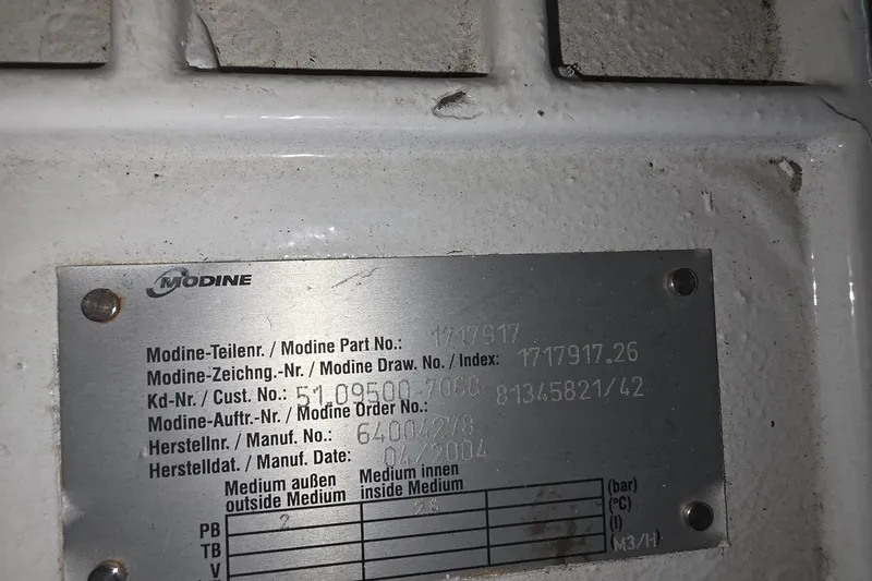 Slide: The Image of Metal identification plate on a 2005 Sea Ray 550 Sedan Bridge, displaying Modine part details. - 77