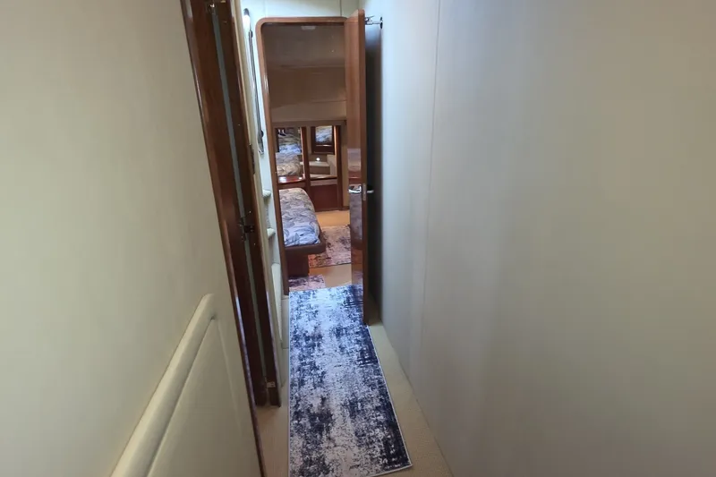 Slide: The Image of Hallway inside 2005 Sea Ray 550 Sedan Bridge yacht, leading to a cozy bedroom. - 50