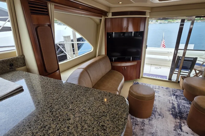 Slide: The Image of Luxurious interior of 2005 Sea Ray 550 Sedan Bridge yacht with granite countertops and leather seating. - 41