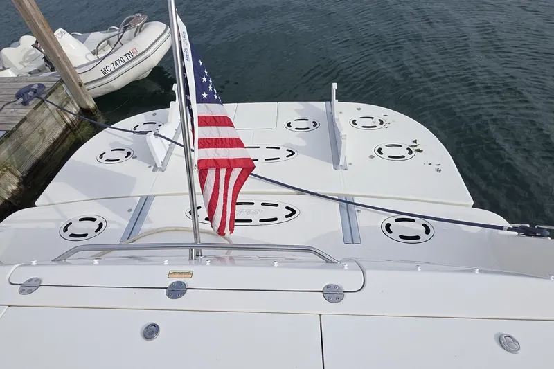 Slide: The Image of 2005 Sea Ray 550 Sedan Bridge yacht with American flag at dock. - 13
