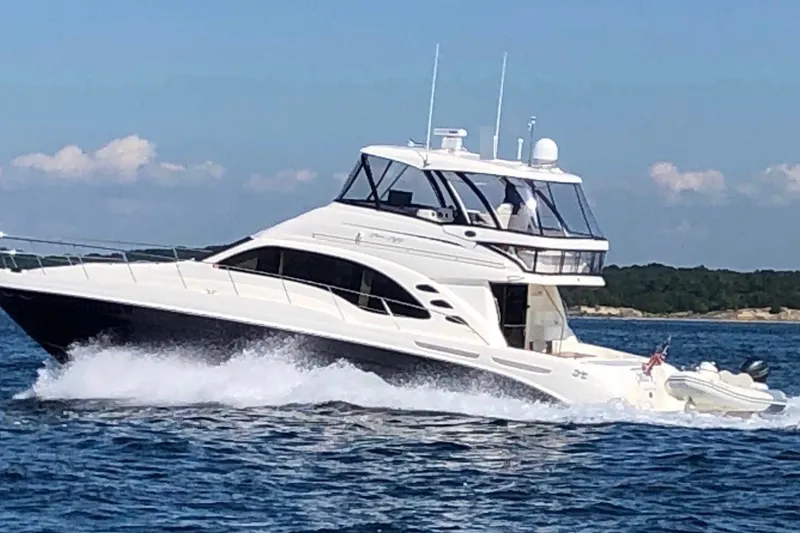 Slide: The Image of 2005 Sea Ray 550 Sedan Bridge yacht cruising on open water. - 9