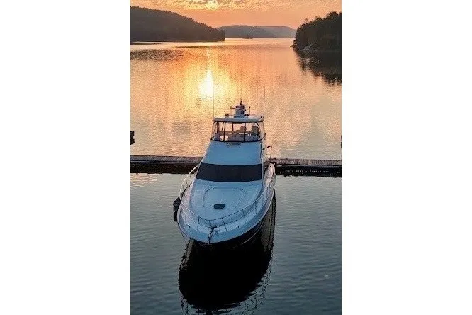 Slide: The Image of 2005 Sea Ray 550 Sedan Bridge yacht at sunset on a tranquil lake. - 10