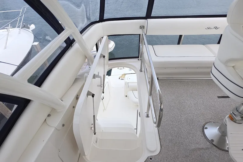 Slide: The Image of Interior view of 2005 Sea Ray 550 Sedan Bridge yacht with stairs and seating area. - 19