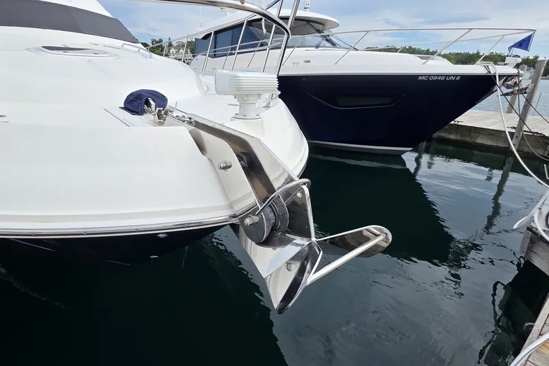 Slide: The Image of 2005 Sea Ray 550 Sedan Bridge yacht docked, featuring a polished anchor and sleek design. - 7
