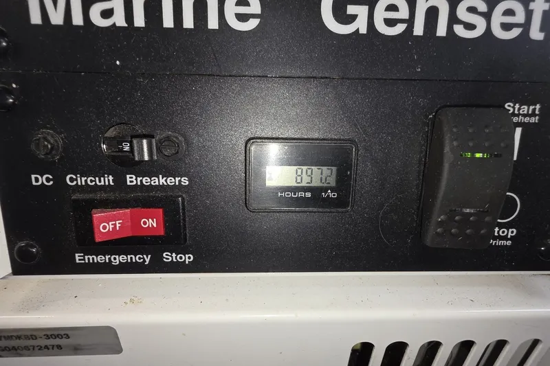 Slide: The Image of Control panel of a 2005 Sea Ray 550 Sedan Bridge marine genset showing 897.2 hours. - 68