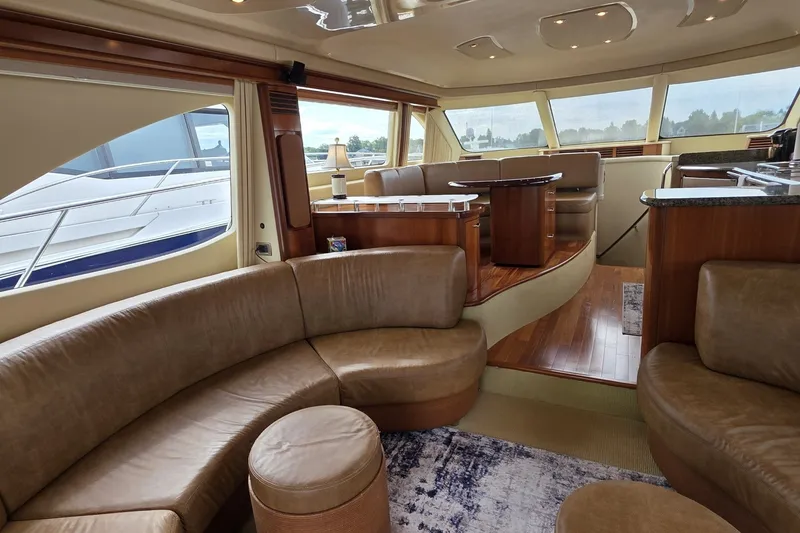 Slide: The Image of Luxurious interior of 2005 Sea Ray 550 Sedan Bridge yacht with leather seating and wood accents. - 31