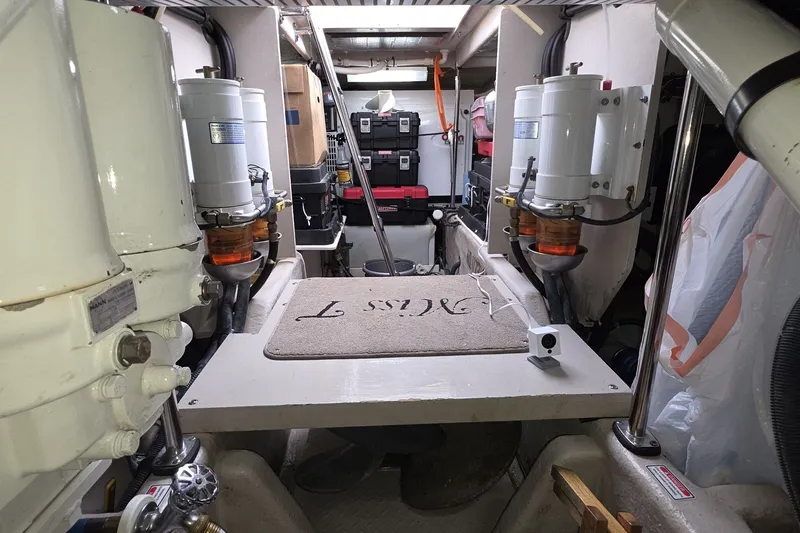 Slide: The Image of Engine room of a 2005 Sea Ray 550 Sedan Bridge yacht, showcasing equipment and storage. - 74