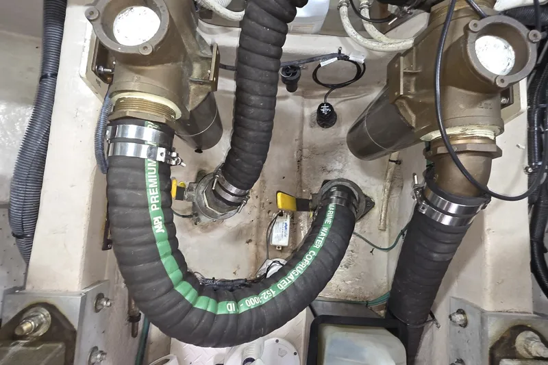 Slide: The Image of Engine room of a 2005 Sea Ray 550 Sedan Bridge with hoses and fittings. - 76