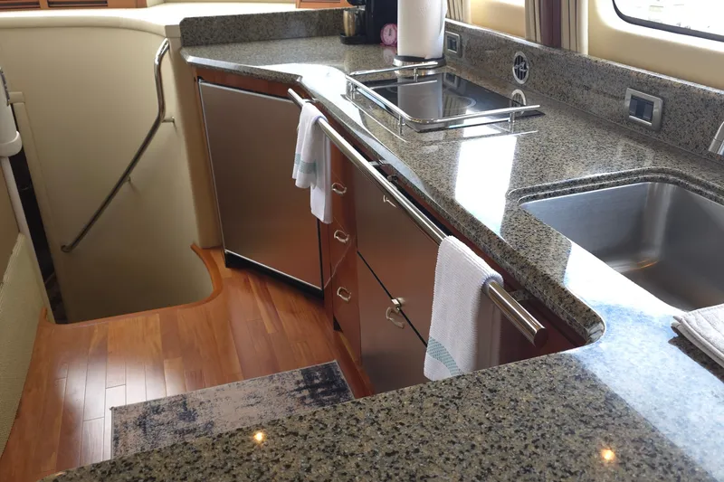 Slide: The Image of Luxurious kitchen area in a 2005 Sea Ray 550 Sedan Bridge yacht with granite countertops. - 36