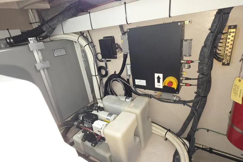 Slide: The Image of Engine room of a 2005 Sea Ray 550 Sedan Bridge with electrical components and wiring. - 73