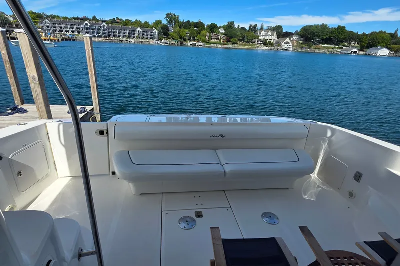Slide: The Image of 2005 Sea Ray 550 Sedan Bridge yacht deck with seating, overlooking serene waterfront. - 63