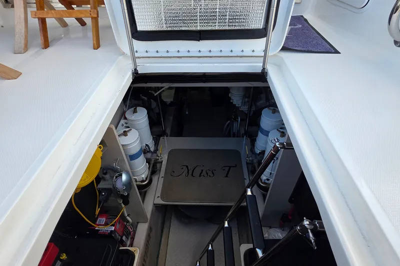 Slide: The Image of Engine room of 2005 Sea Ray 550 Sedan Bridge yacht, featuring equipment and access hatch. - 78