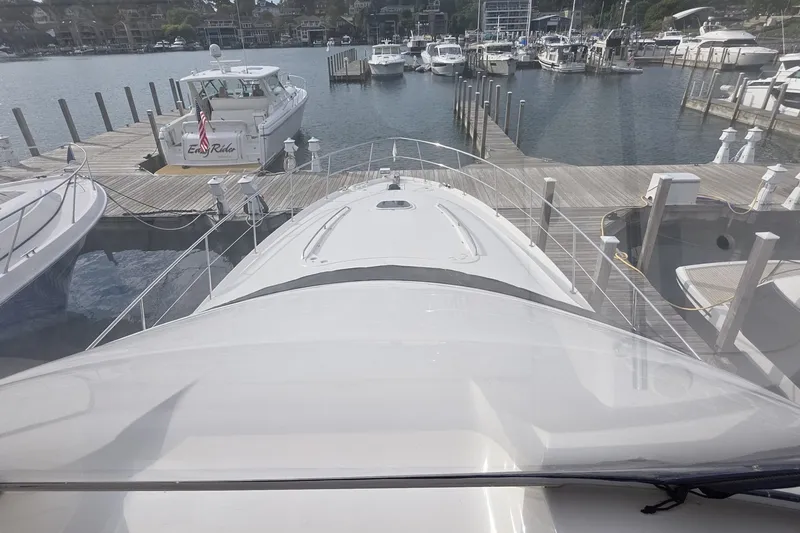 Slide: The Image of 2005 Sea Ray 550 Sedan Bridge yacht docked at marina, surrounded by other boats. - 30