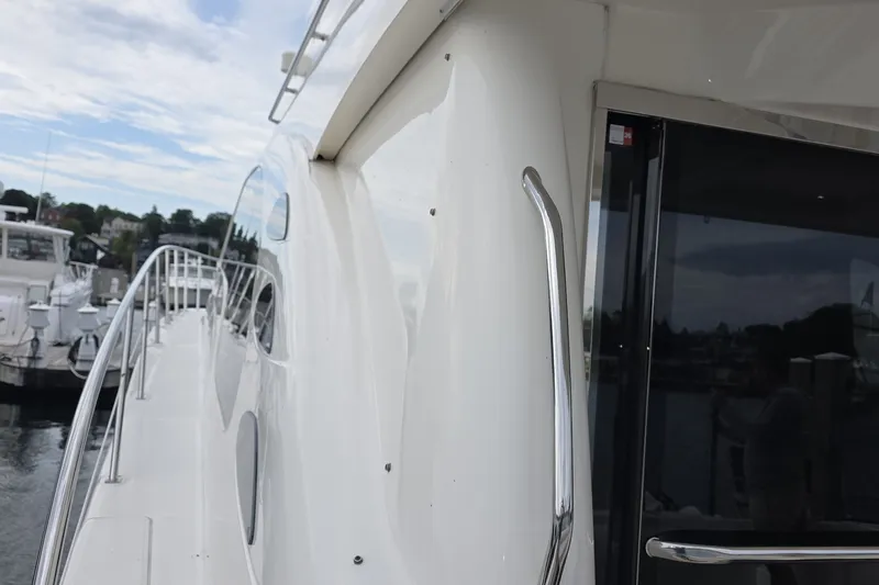 Slide: The Image of 2005 Sea Ray 550 Sedan Bridge yacht docked at marina, side view. - 15