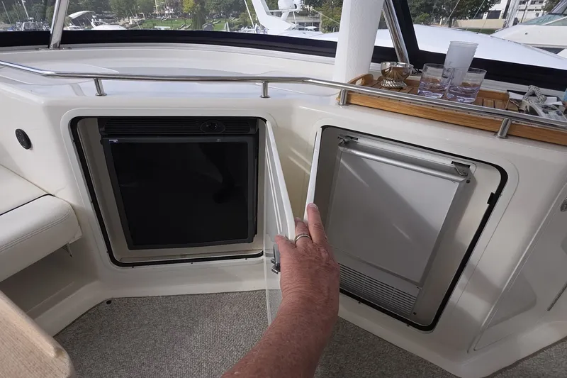 Slide: The Image of Interior view of a 2005 Sea Ray 550 Sedan Bridge yacht with open mini fridge. - 28