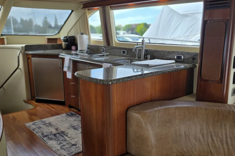 Slide: The Image of Luxurious interior of 2005 Sea Ray 550 Sedan Bridge yacht with modern kitchen amenities. - 37