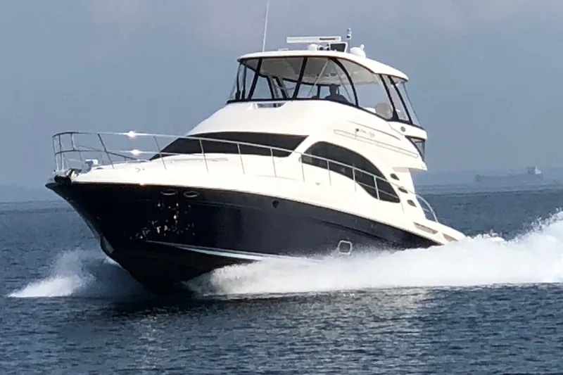 Slide: The Image of 2005 Sea Ray 550 Sedan Bridge yacht cruising on open water. - 5