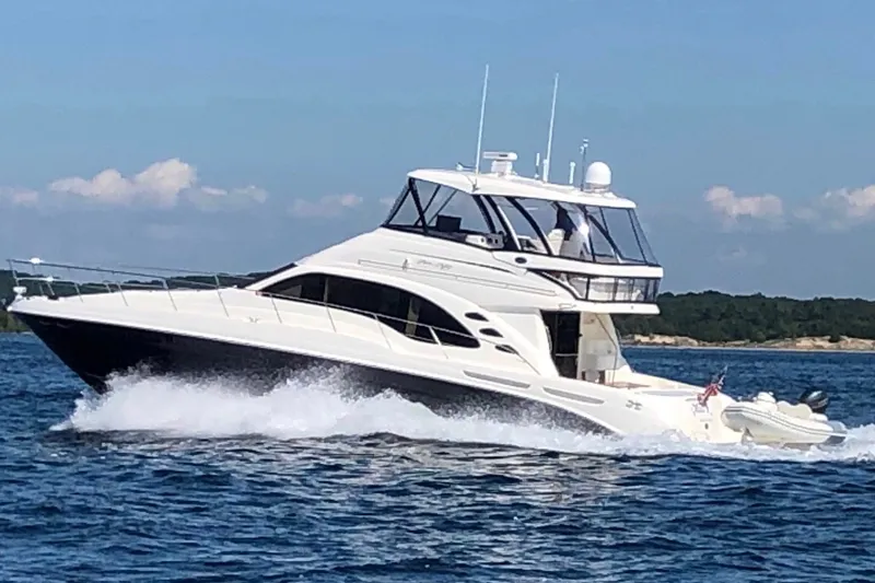 Slide: The Image of 2005 Sea Ray 550 Sedan Bridge yacht cruising on open water. - 9