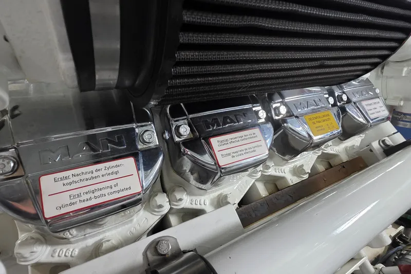 Slide: The Image of Engine components of a 2005 Sea Ray 550 Sedan Bridge with MAN branding. - 72