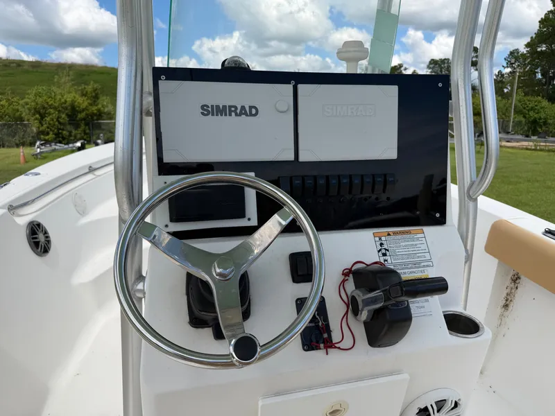 Slide: The Image of The image shows the helm of a 2015 Sea Fox 236 Center Console boat. - 15
