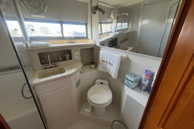 Slide: The Image of Bathroom of 1995 Carver 355 Aft Cabin Motor Yacht with sink, toilet, and shower. - 19