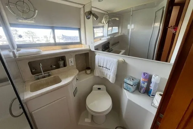 Slide: The Image of Bathroom interior of 1995 Carver 355 Aft Cabin Motor Yacht, featuring sink and toilet. - 25