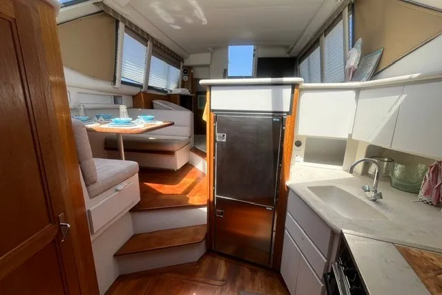 Slide: The Image of Interior of 1995 Carver 355 Aft Cabin Motor Yacht with kitchen and dining area. - 21