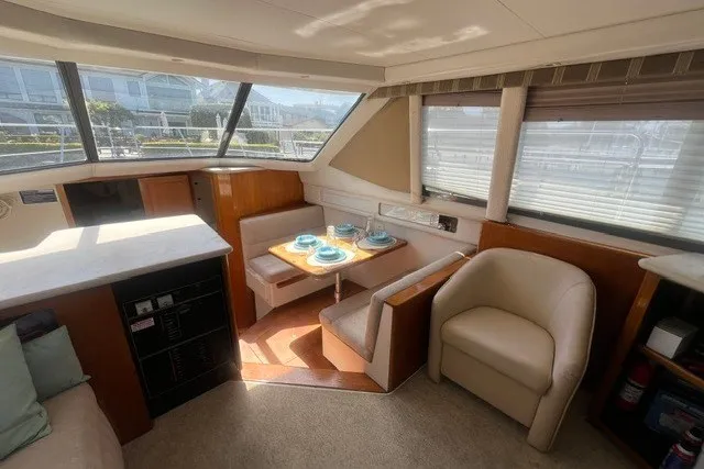 Slide: The Image of Interior of 1995 Carver 355 Aft Cabin Motor Yacht with dining area and seating. - 13