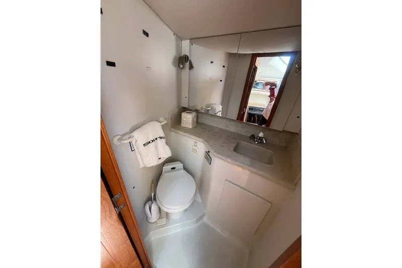 Slide: The Image of Bathroom interior of 1995 Carver 355 Aft Cabin Motor Yacht, featuring sink and toilet. - 15