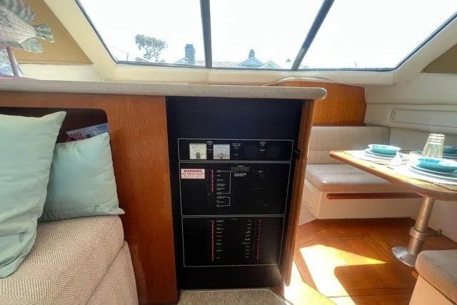 Slide: The Image of Interior of 1995 Carver 355 Aft Cabin Motor Yacht with control panel and dining area. - 23