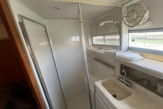 Slide: The Image of 1995 Carver 355 Aft Cabin Motor Yacht bathroom with shower, sink, and window. - 20